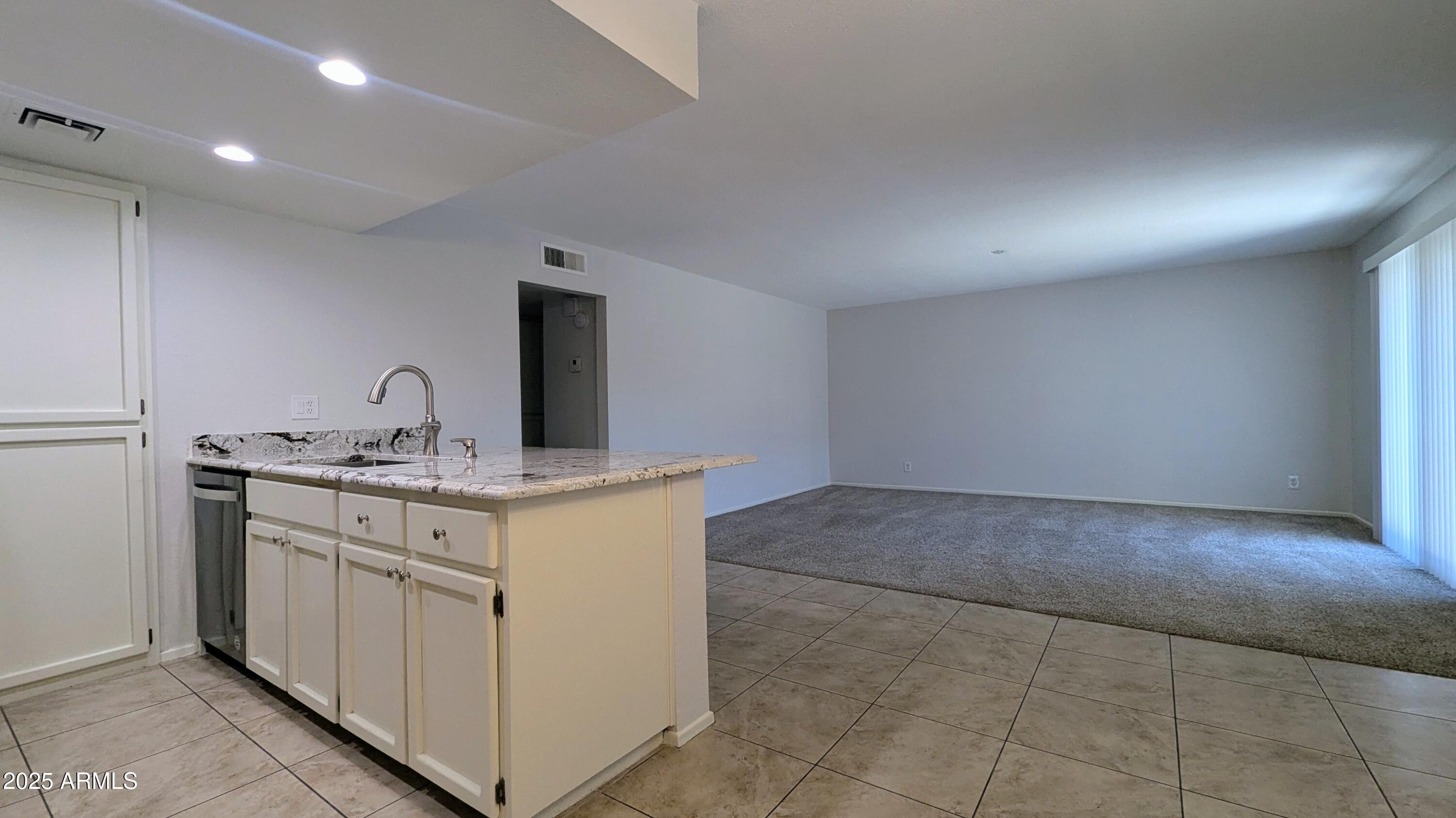 2228 East Campbell Avenue, Unit 234 Phoenix, AZ 85016 - Photo 10 of 18 a kitchen with a sink and cabinets