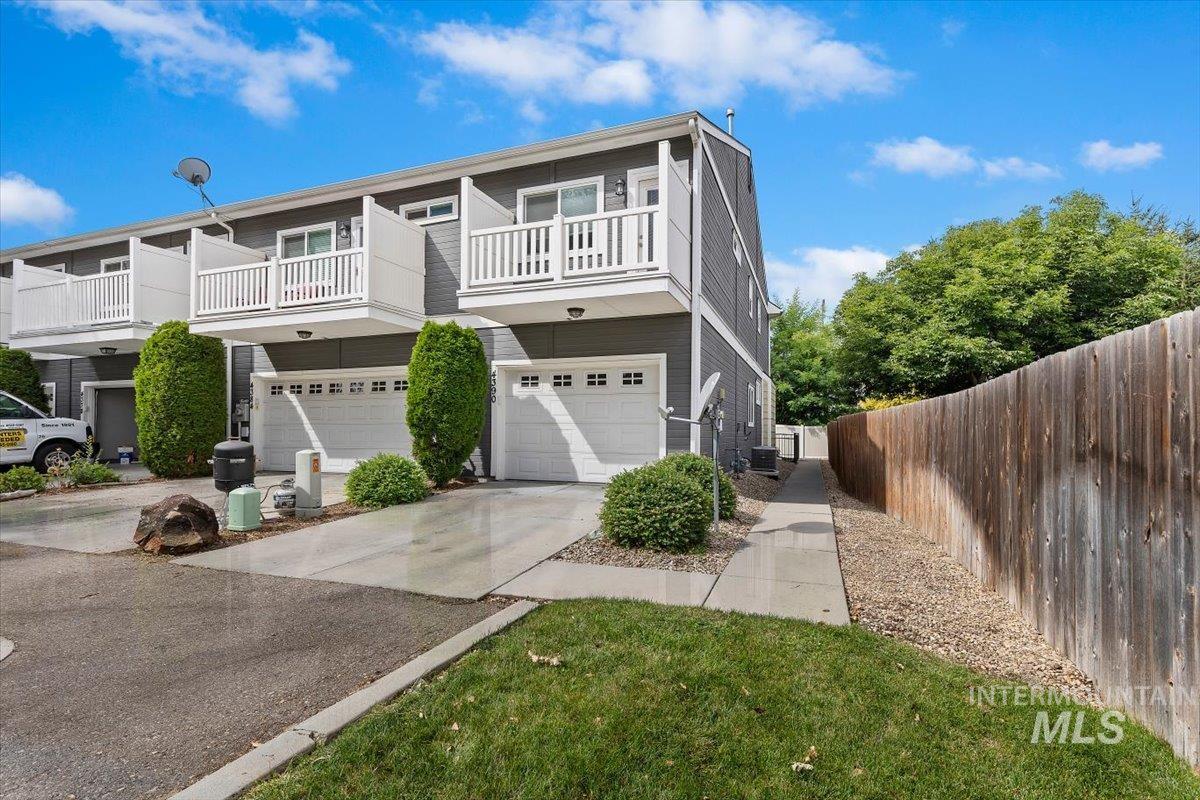 4390 North Five Mile Road Boise, ID 83704 - Photo 3 of 23 Exterior featuring gray siding, white garage doors, and white balcony railings