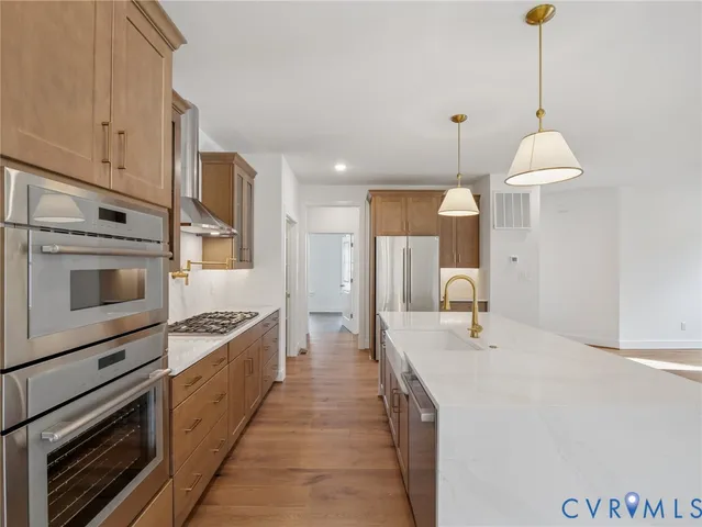 a kitchen with a sink and stainless steel appliances