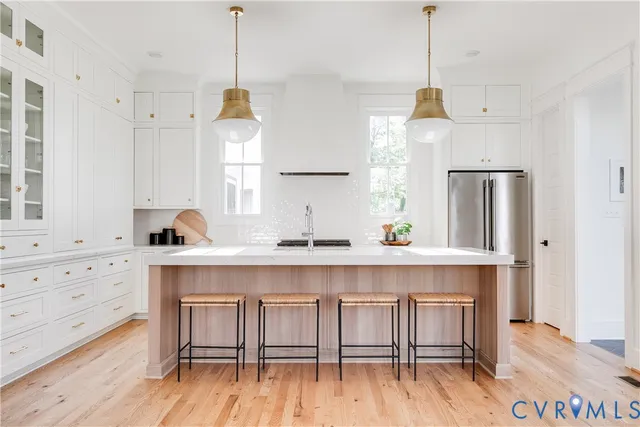 a dining room with furniture a chandelier and window