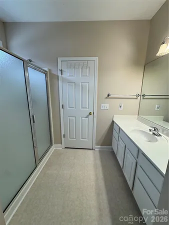 a bathroom with a sink a mirror and a vanity