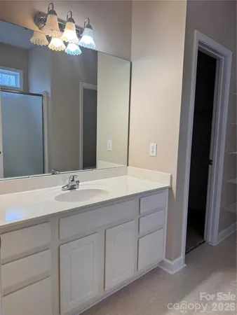 a bathroom with a double vanity sink and a mirror