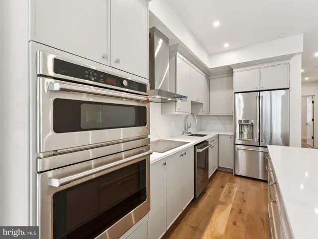 a kitchen with a stove microwave and a refrigerator