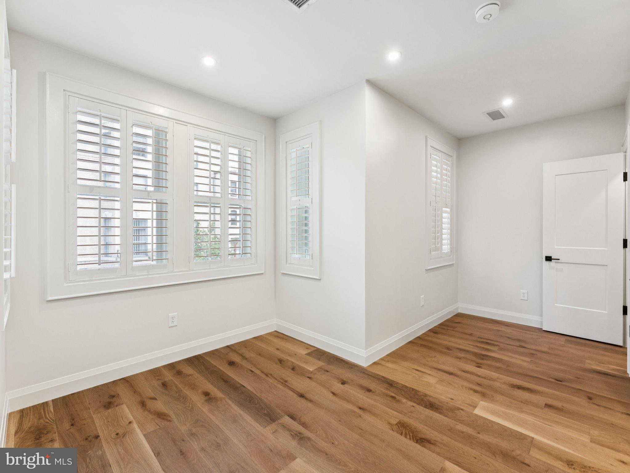 1508 21st Street Northwest, Unit 1 Washington, DC 20036 - Photo 13 of 40 a view of empty room with wooden floor and fan
