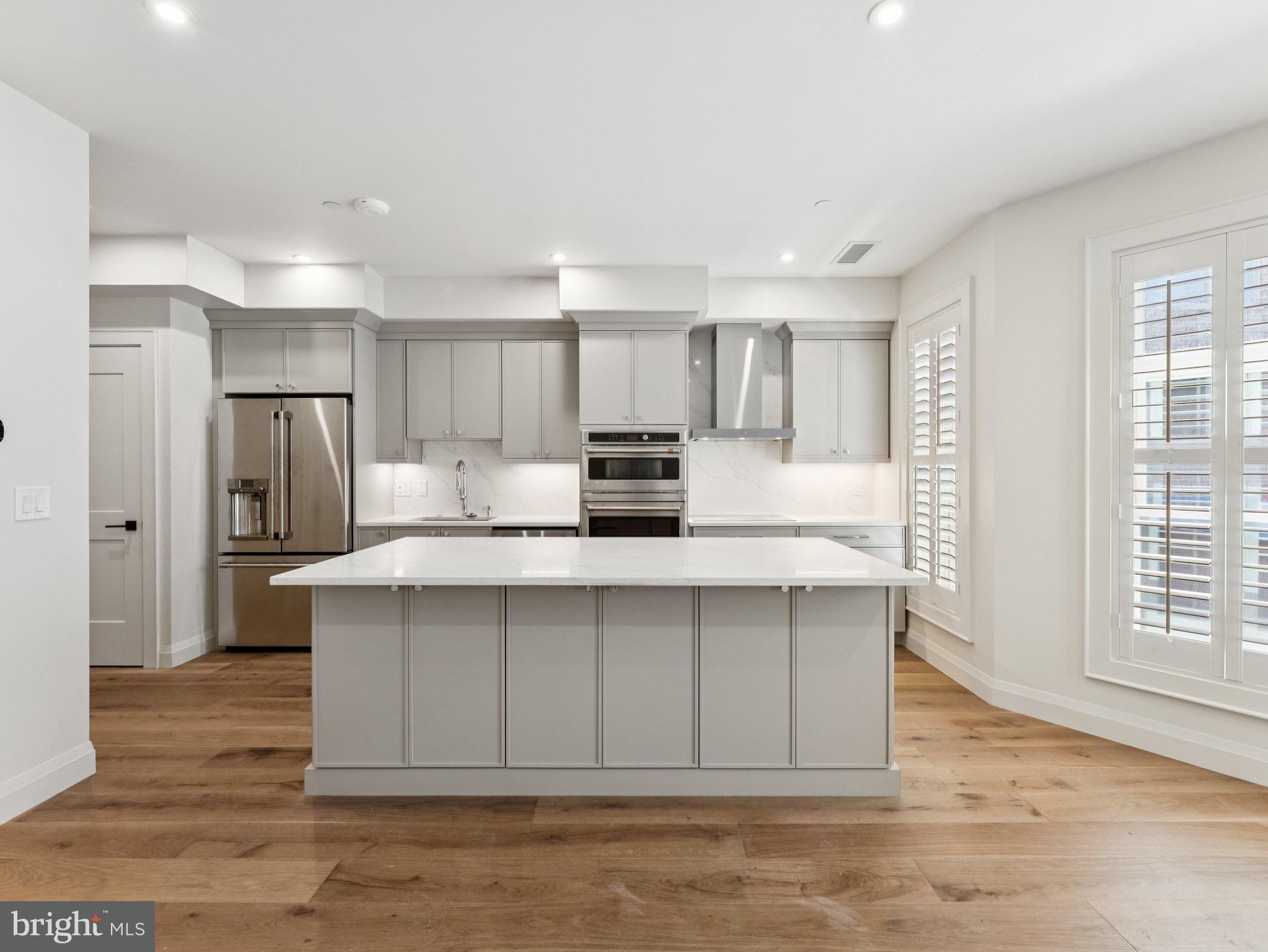 1508 21st Street Northwest, Unit 1 Washington, DC 20036 - Photo 19 of 40 a kitchen with stainless steel appliances a refrigerator and a stove top oven