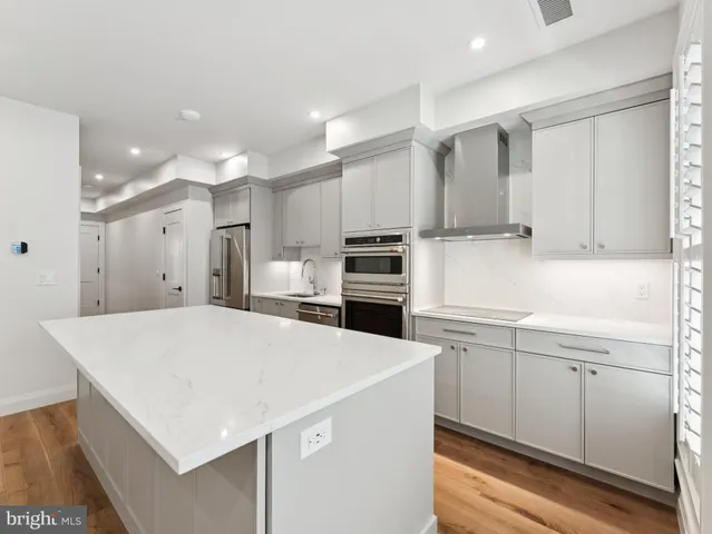 a kitchen with a sink a stove and refrigerator