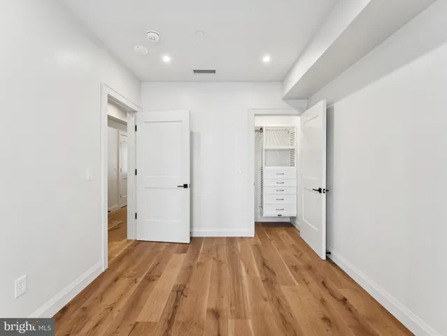 a view of hallway with wooden floor