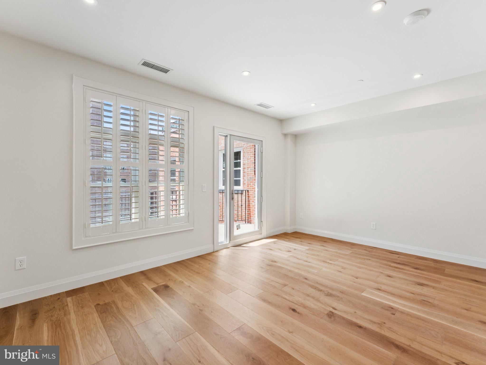 1508 21st Street Northwest, Unit 1 Washington, DC 20036 - Photo 27 of 40 a view of an empty room with wooden floor and a window