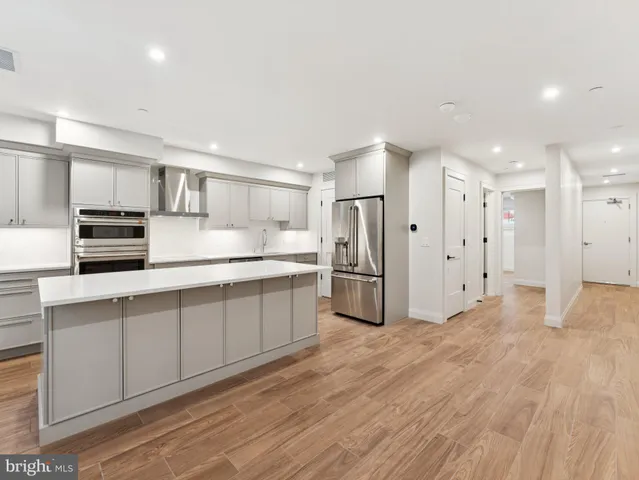 a kitchen with stainless steel appliances a refrigerator and a sink