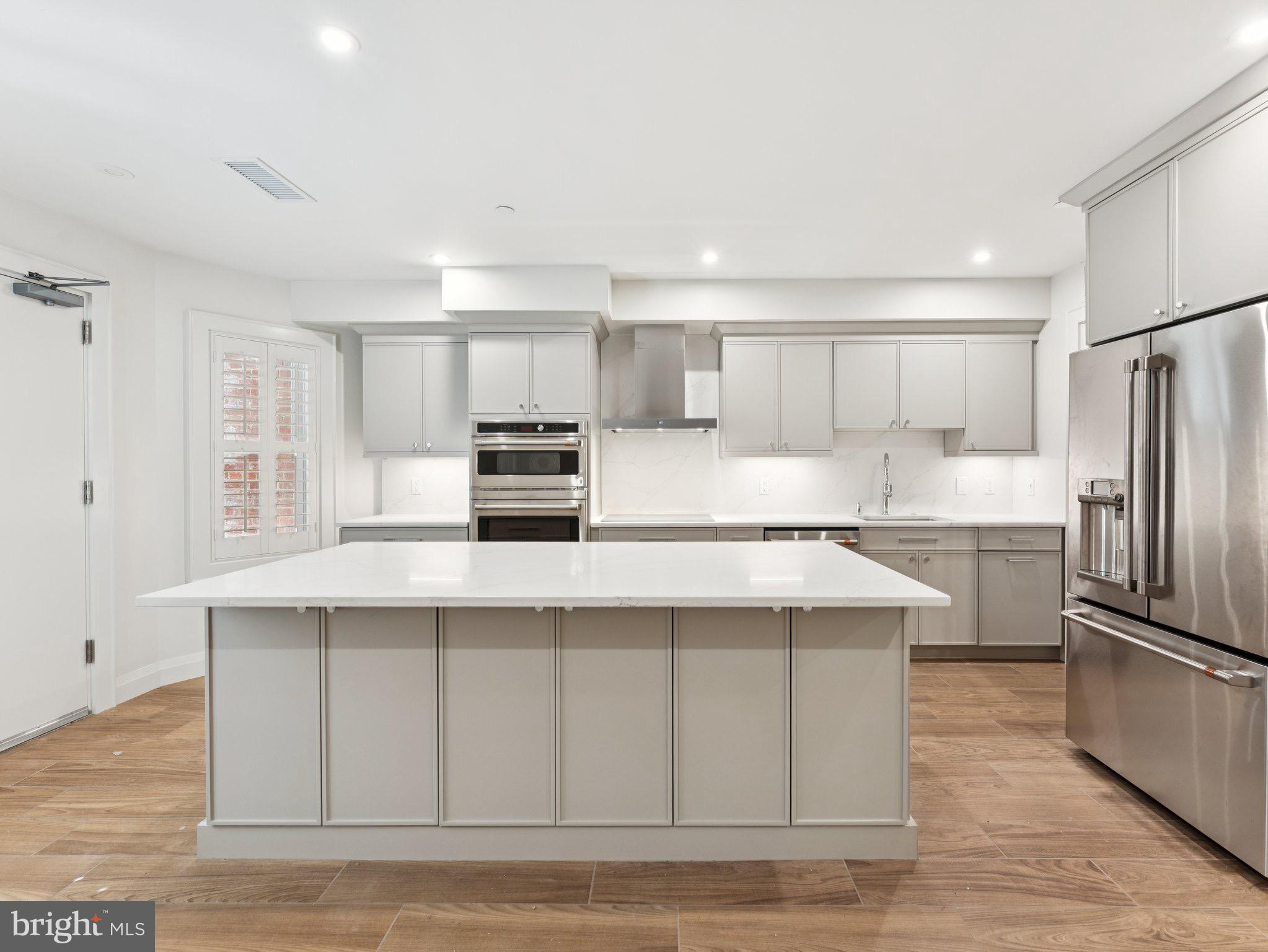 1508 21st Street Northwest, Unit 1 Washington, DC 20036 - Photo 30 of 40 a kitchen with stainless steel appliances a stove a sink and a refrigerator