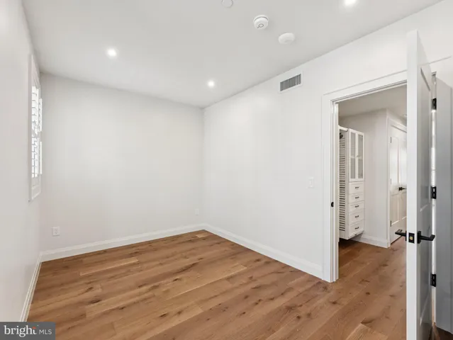 a view of a room with wooden floor