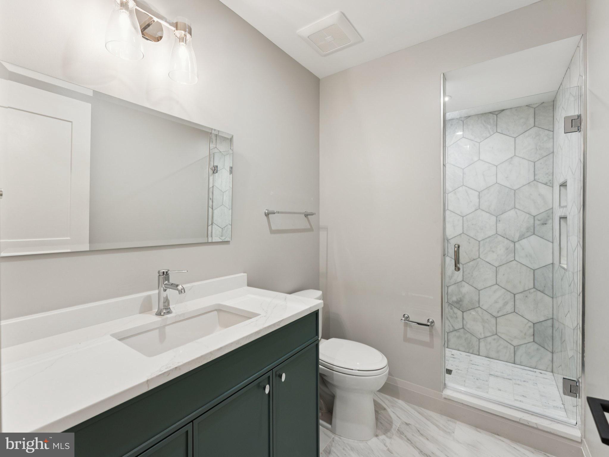 1508 21st Street Northwest, Unit 1 Washington, DC 20036 - Photo 33 of 40 a bathroom with a sink a toilet and shower