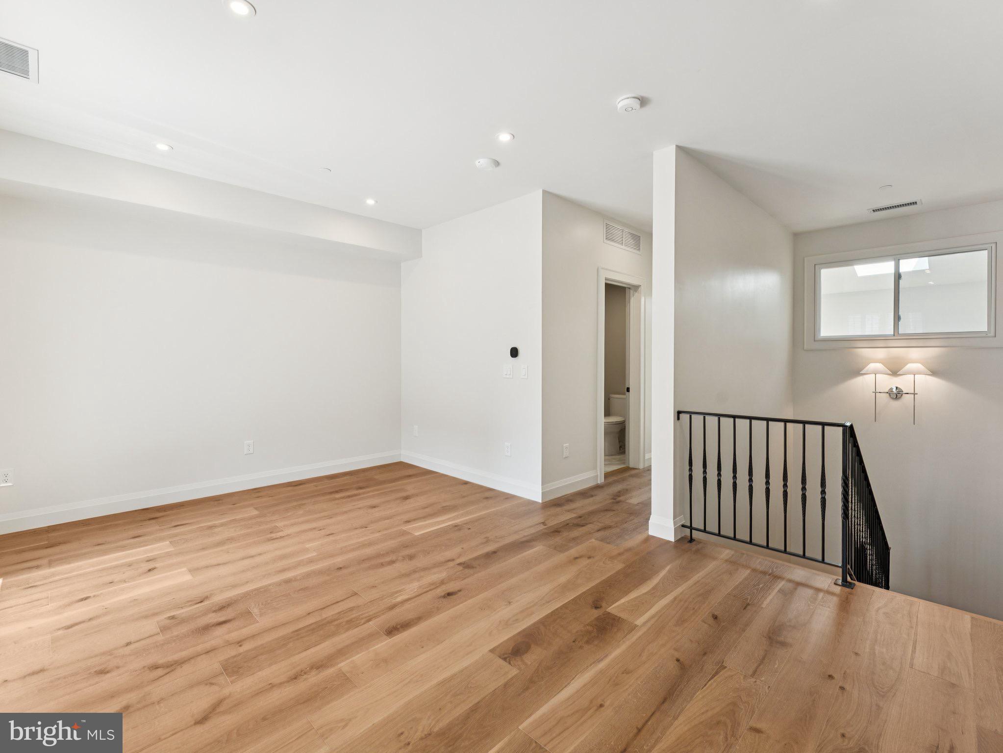 1508 21st Street Northwest, Unit 1 Washington, DC 20036 - Photo 37 of 40 a view of an empty room with wooden floor