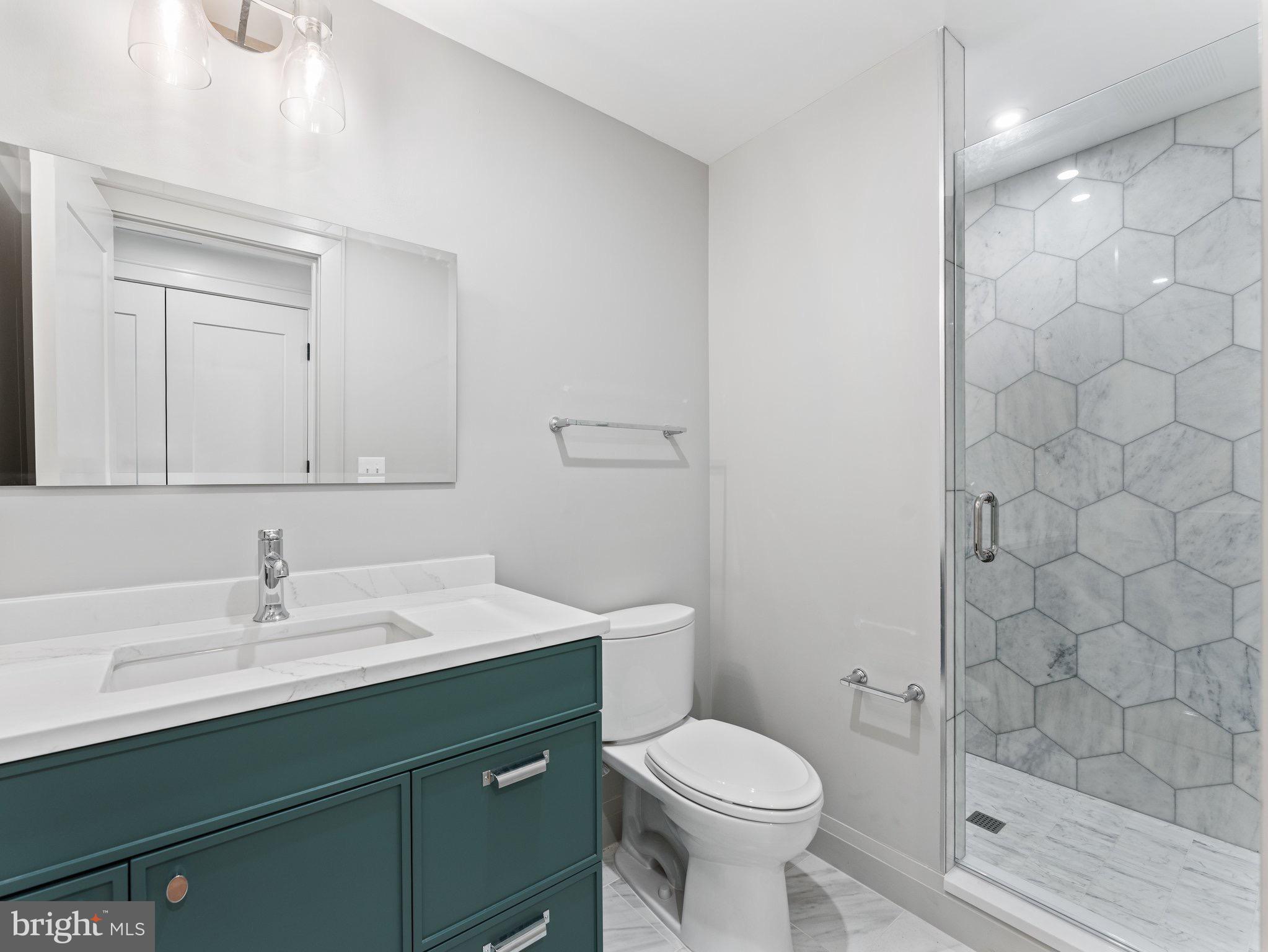 1508 21st Street Northwest, Unit 1 Washington, DC 20036 - Photo 4 of 40 a bathroom with a sink toilet and shower