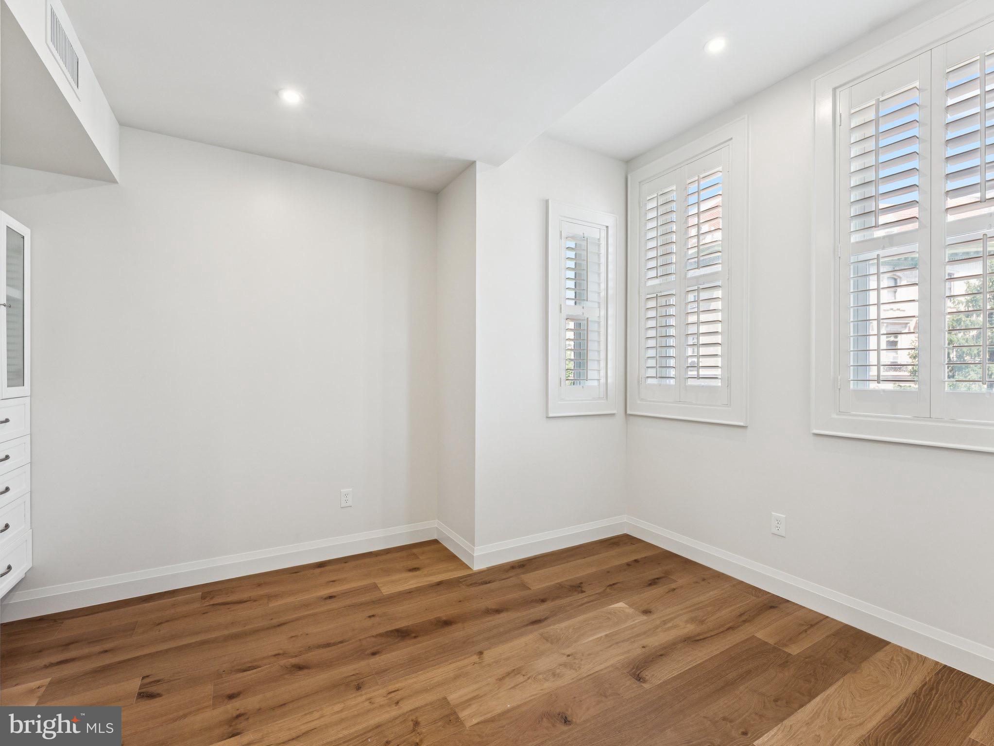 1508 21st Street Northwest, Unit 1 Washington, DC 20036 - Photo 5 of 40 a view of empty room with wooden floor and fan