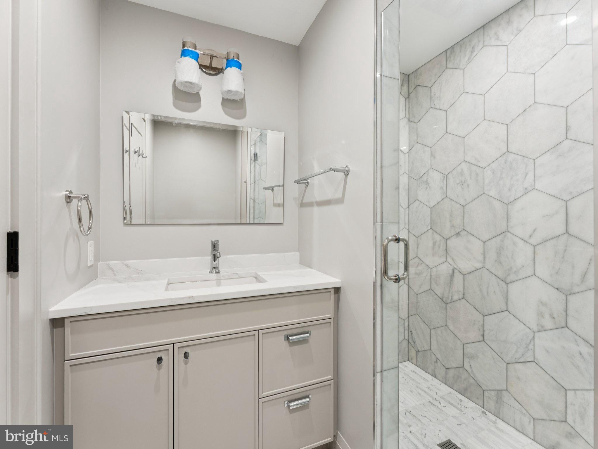 1508 21st Street Northwest, Unit 1 Washington, DC 20036 - Photo 7 of 40 a bathroom with a sink and a mirror