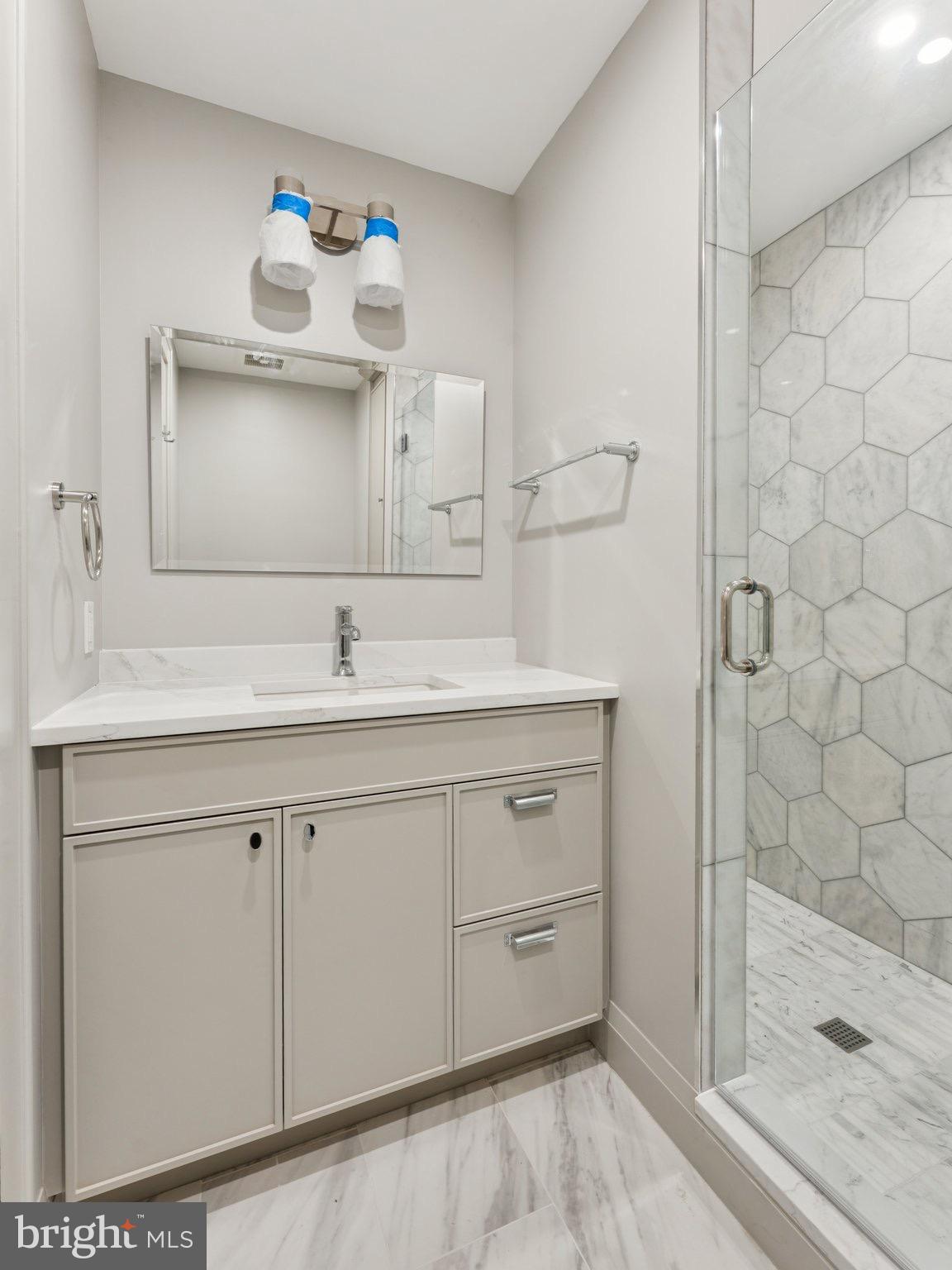 1508 21st Street Northwest, Unit 1 Washington, DC 20036 - Photo 8 of 40 a bathroom with a sink and a mirror