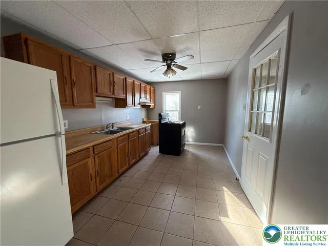 a kitchen with stainless steel appliances granite countertop a refrigerator and a stove