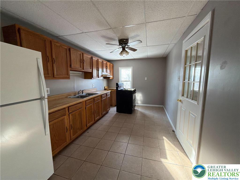 934 Butler Street Easton, PA 18042 - Photo 6 of 14 a kitchen with stainless steel appliances granite countertop a refrigerator and a stove