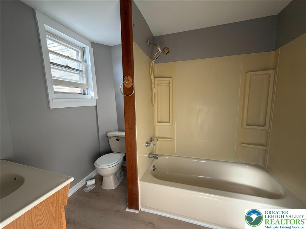 934 Butler Street Easton, PA 18042 - Photo 9 of 14 a bath room with a toilet and a bath tub