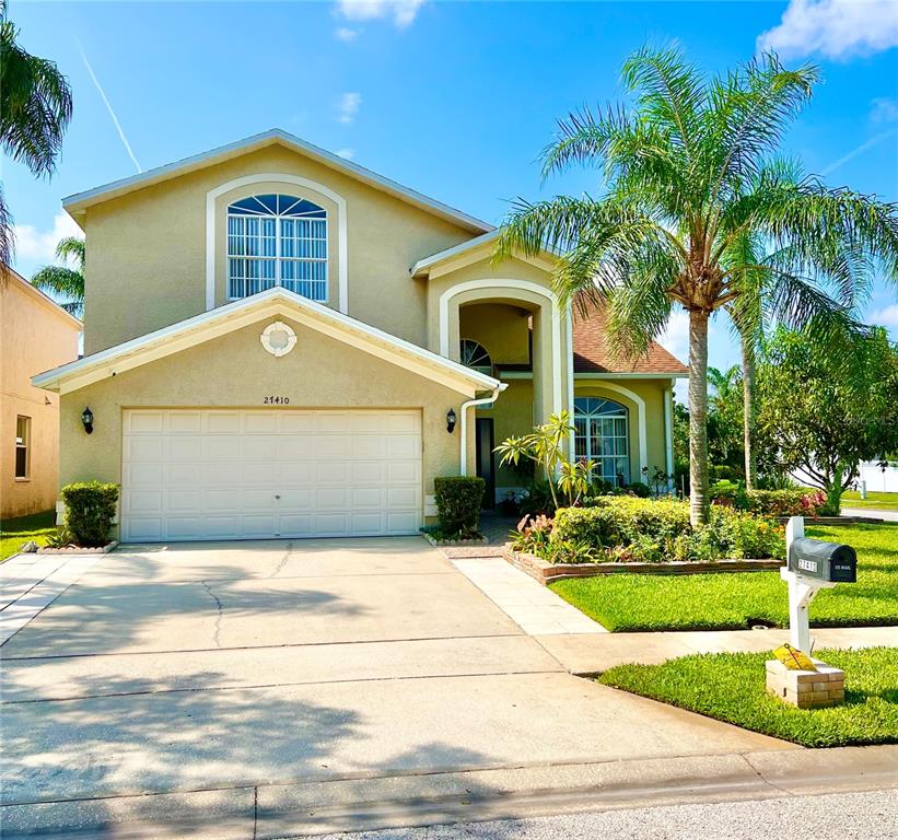a front view of a house with a yard and garage