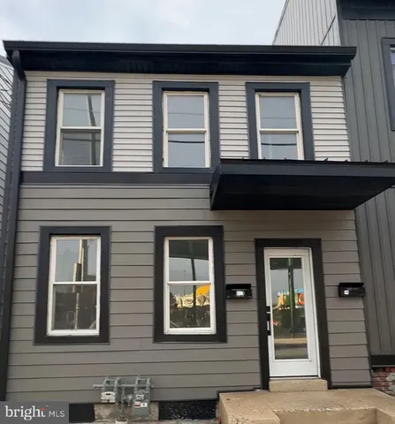 a view of a brick house with large windows