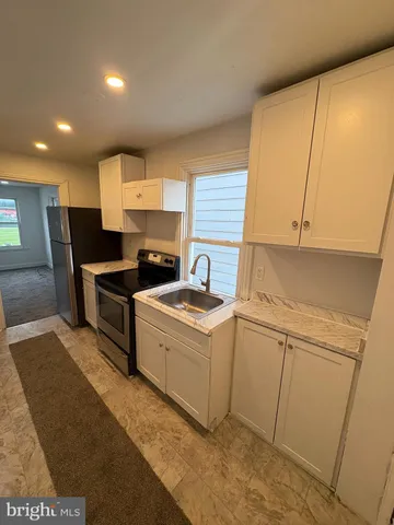 a view of hallway with wooden floor
