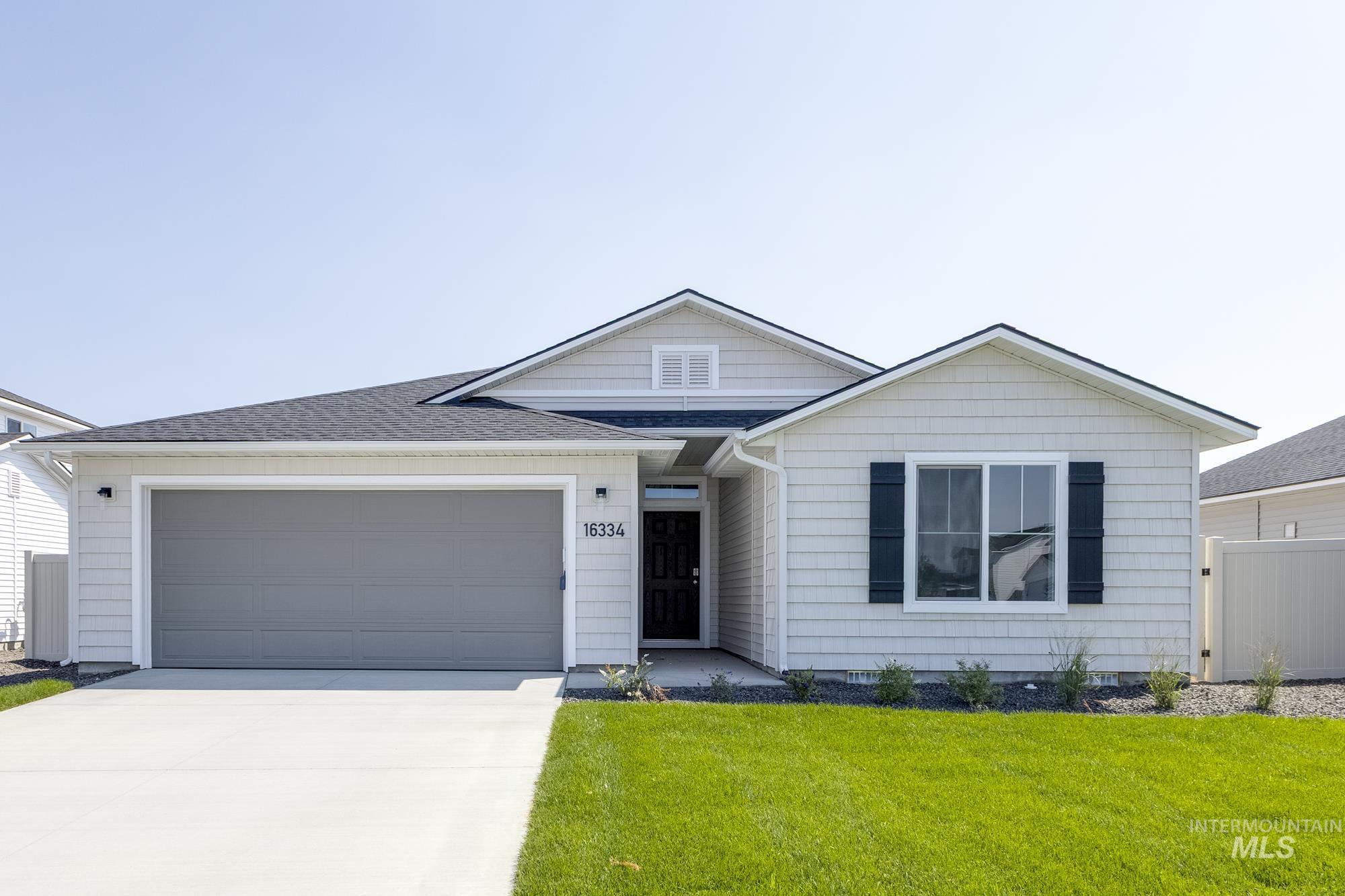16334 Backfill Avenue Caldwell, ID 83607 - Photo 1 of 1 Ranch-style home with concrete driveway, a garage, and roof with shingles