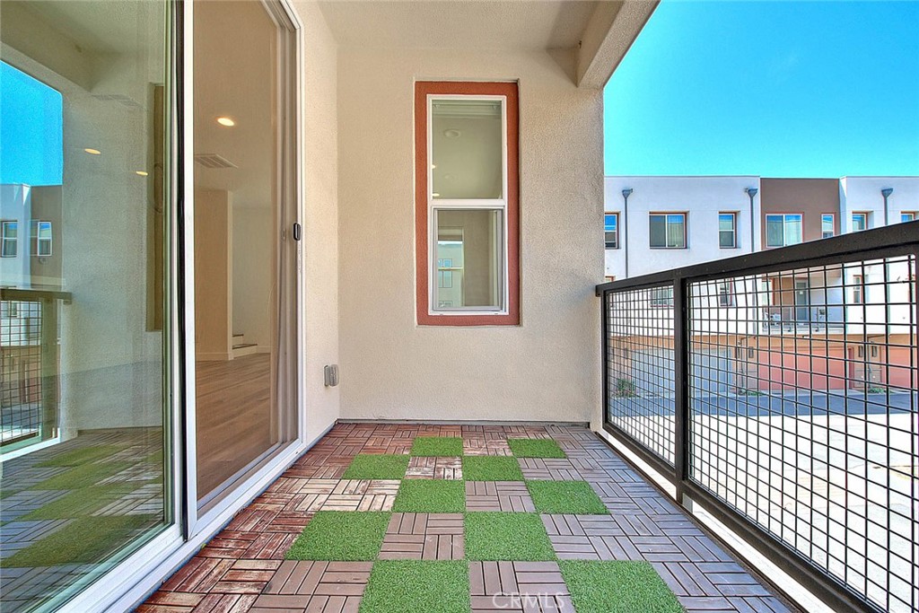 11411 VuePointe Way, Unit E El Monte, CA 91732 - Photo 18 of 38 a view of balcony with a floor to ceiling window and wooden floor