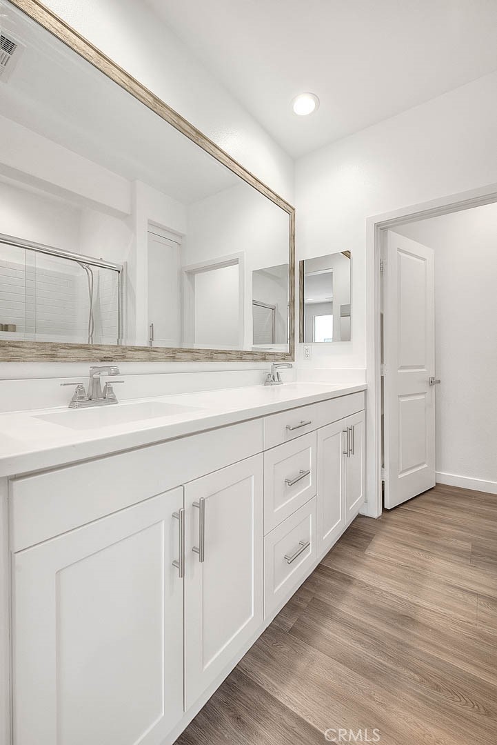 11411 VuePointe Way, Unit E El Monte, CA 91732 - Photo 25 of 38 a spacious bathroom with a double vanity sink and mirror