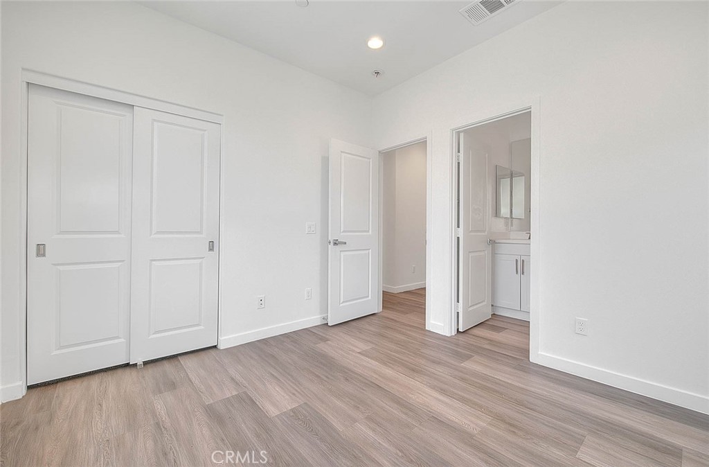 11411 VuePointe Way, Unit E El Monte, CA 91732 - Photo 29 of 38 a view of an empty room with wooden floor