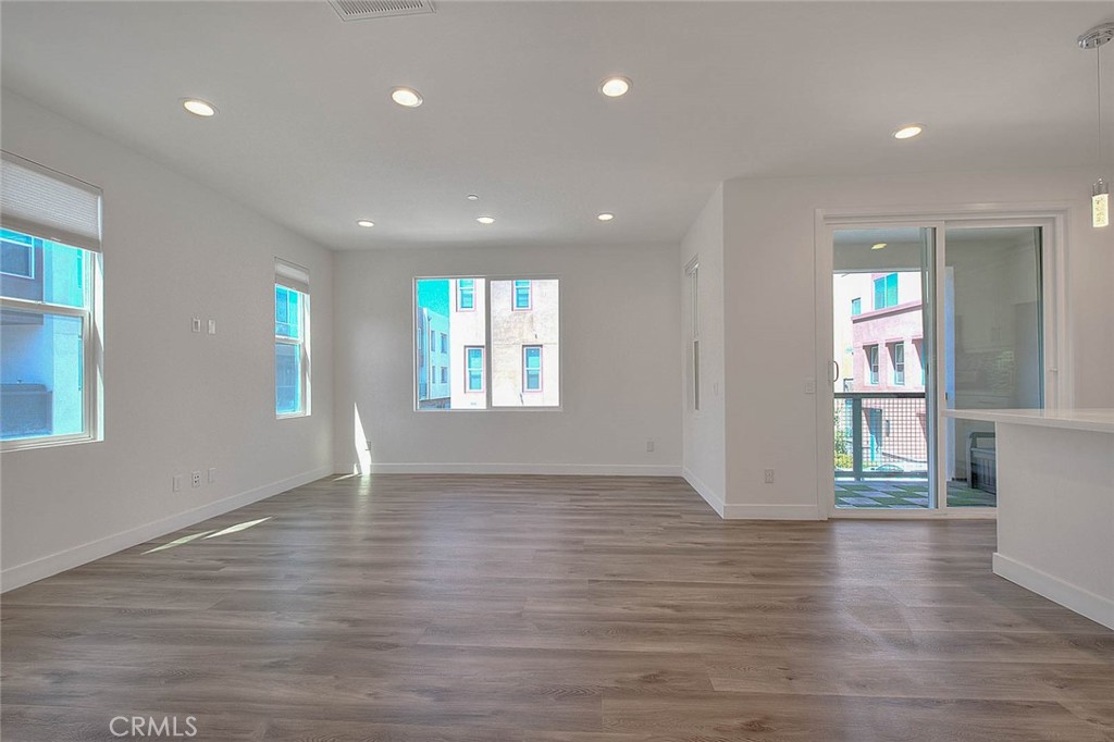 11411 VuePointe Way, Unit E El Monte, CA 91732 - Photo 5 of 38 a view of an empty room with wooden floor and a window