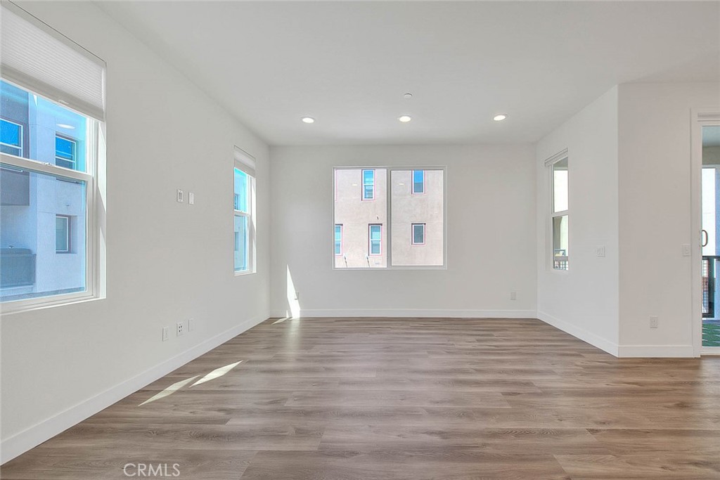 11411 VuePointe Way, Unit E El Monte, CA 91732 - Photo 8 of 38 a view of an empty room with wooden floor and a window