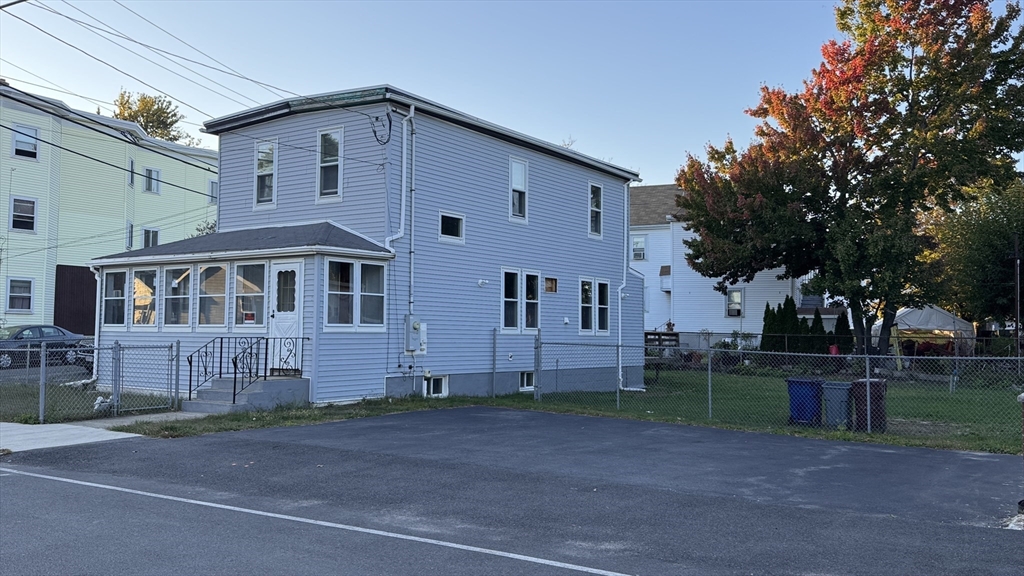 80 Jones Road Revere, MA 02151 - Photo 6 of 14 a front view of a house with a yard