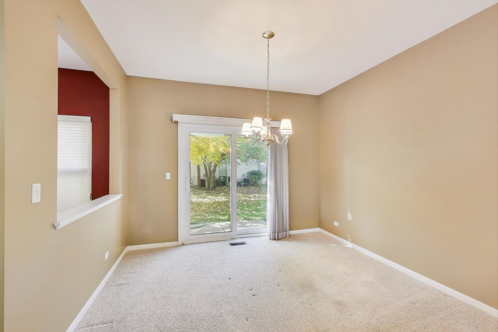 2271 Stoughton Circle Aurora, IL 60502 - Photo 11 of 34 a view of an empty room with windows and outdoor view