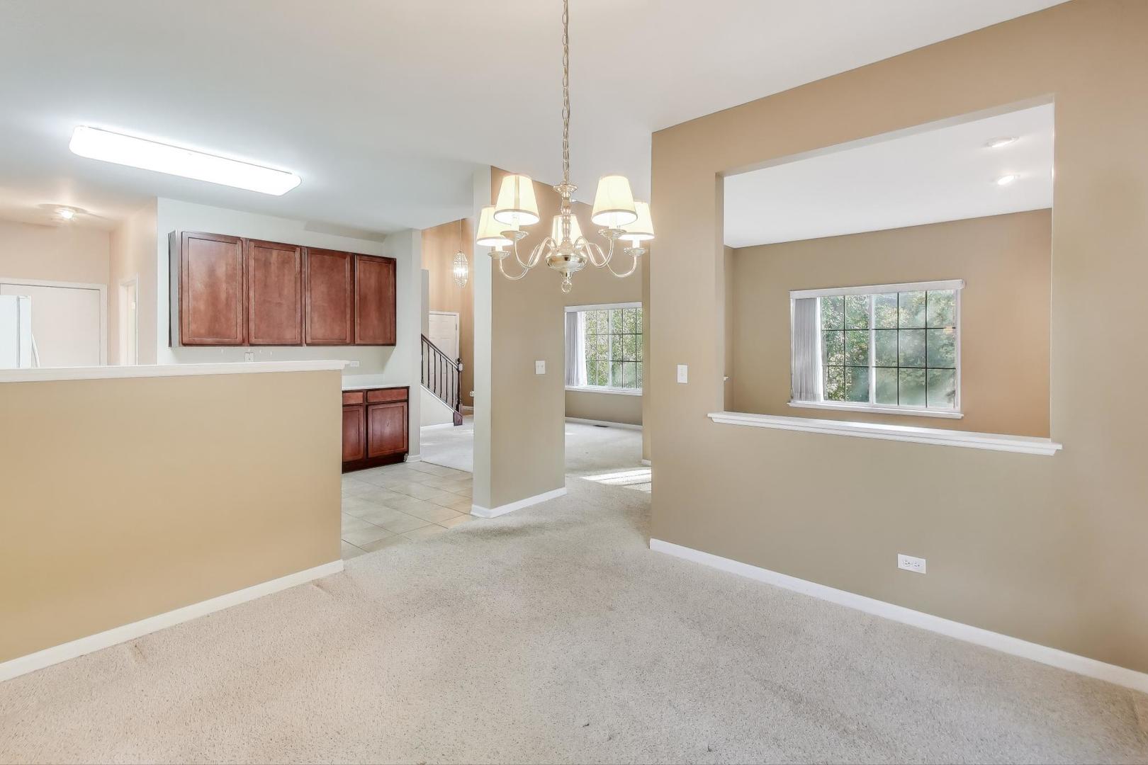 2271 Stoughton Circle Aurora, IL 60502 - Photo 12 of 34 a view of a room with window and chandelier