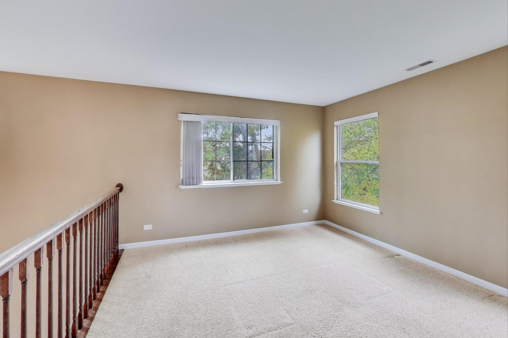 2271 Stoughton Circle Aurora, IL 60502 - Photo 17 of 34 a view of an empty room with windows