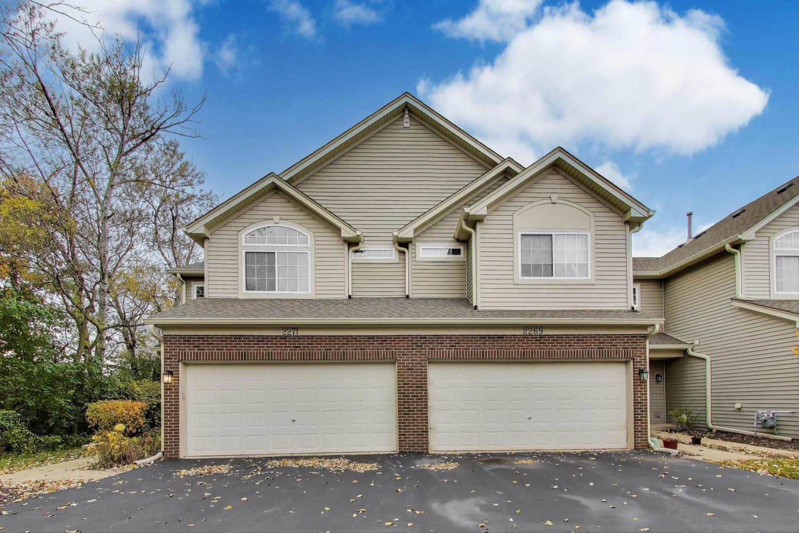 2271 Stoughton Circle Aurora, IL 60502 - Photo 2 of 34 a view of a house with a yard and garage
