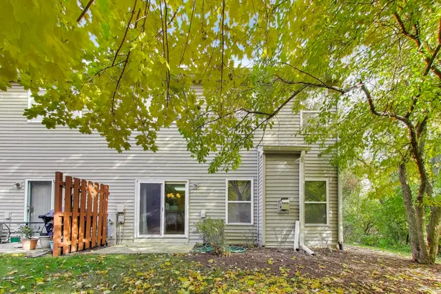 a backyard of a house with table and chairs