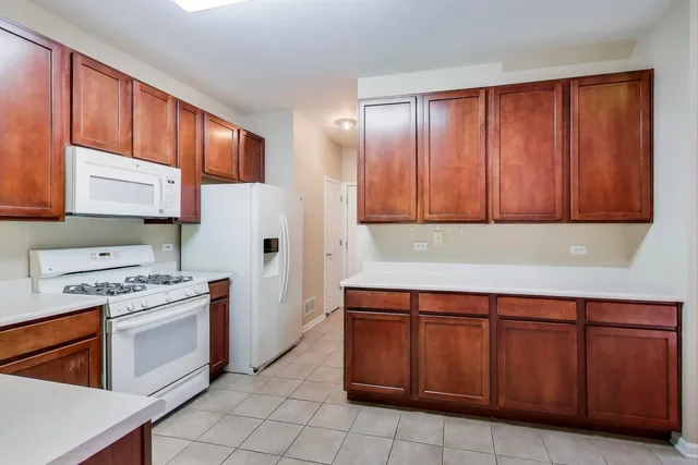 a kitchen with stainless steel appliances granite countertop wooden cabinets a sink and a stove