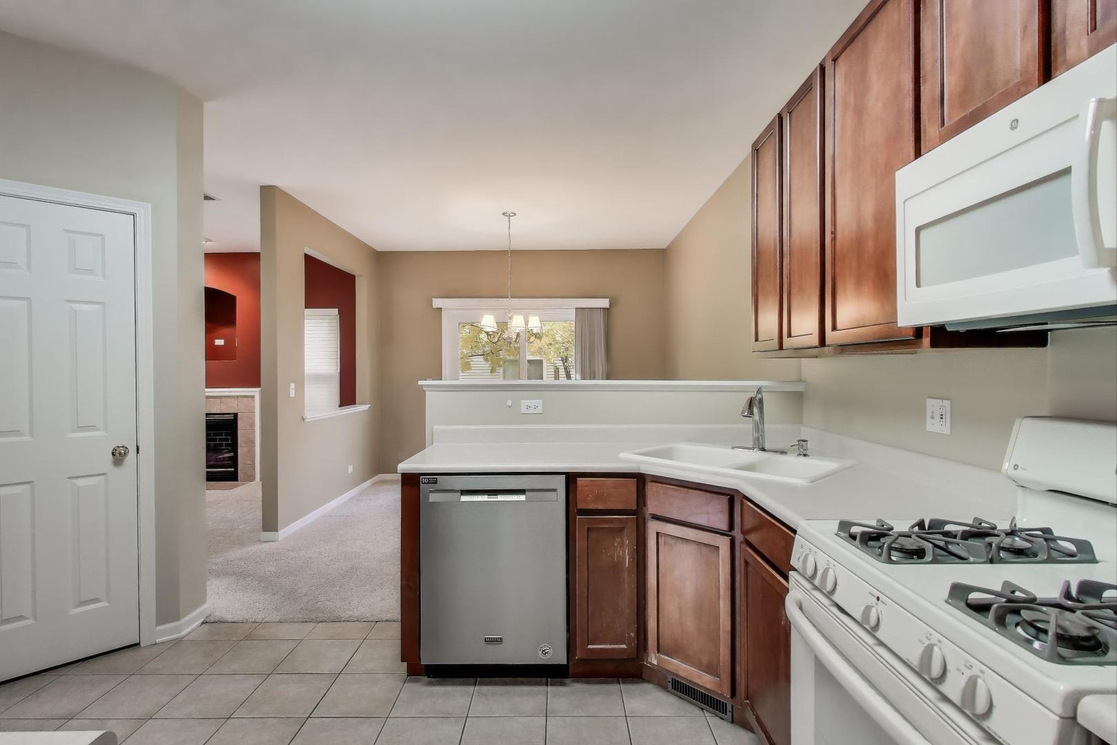 2271 Stoughton Circle Aurora, IL 60502 - Photo 8 of 34 a kitchen with a sink stove and cabinets