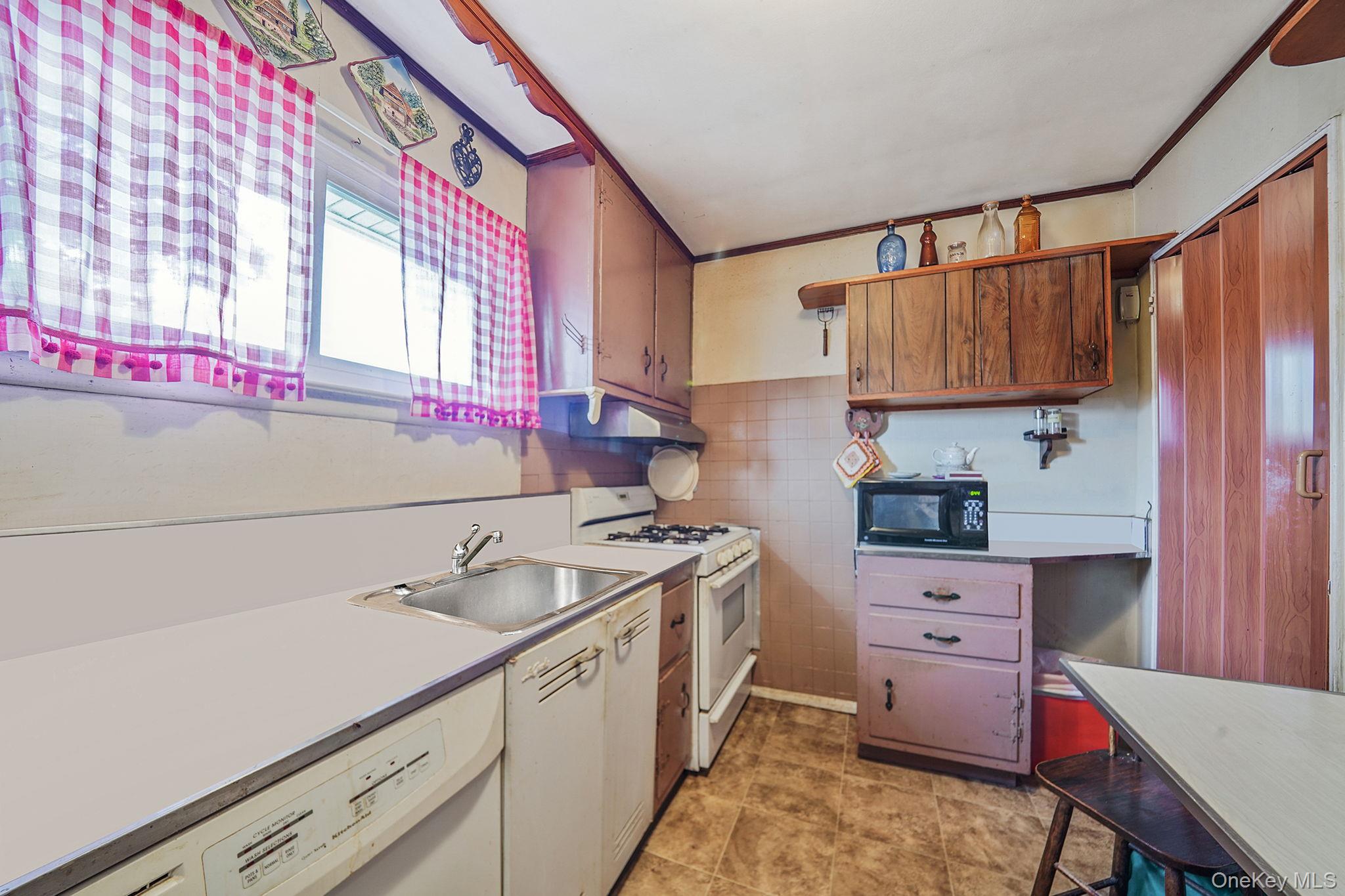 2 Sydney Street Plainview, NY 11803 - Photo 13 of 26 a kitchen with a sink cabinets and a window