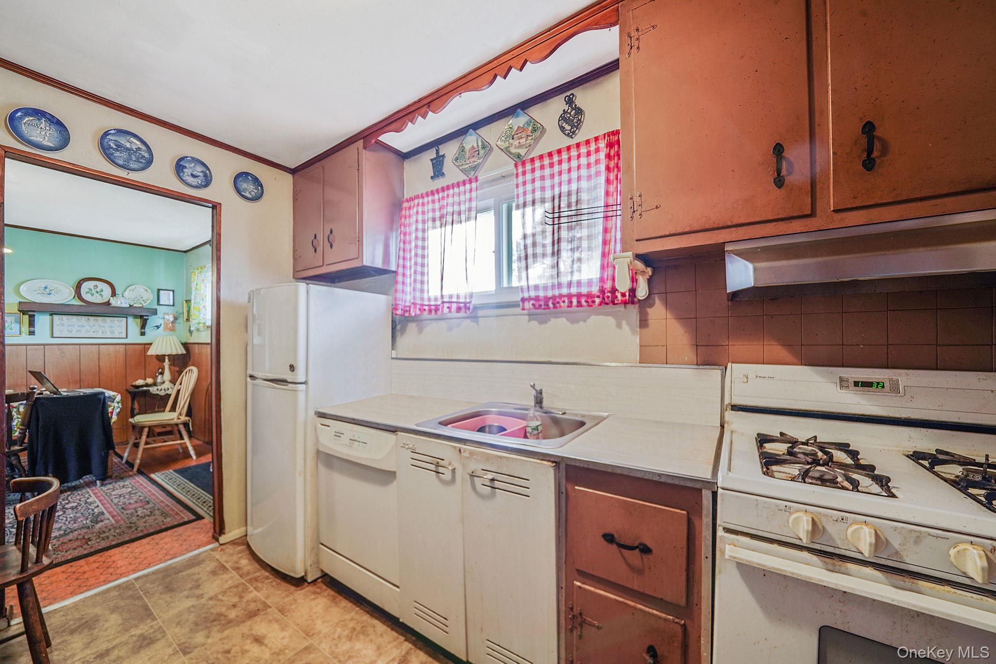 2 Sydney Street Plainview, NY 11803 - Photo 14 of 26 a kitchen with a stove and a refrigerator