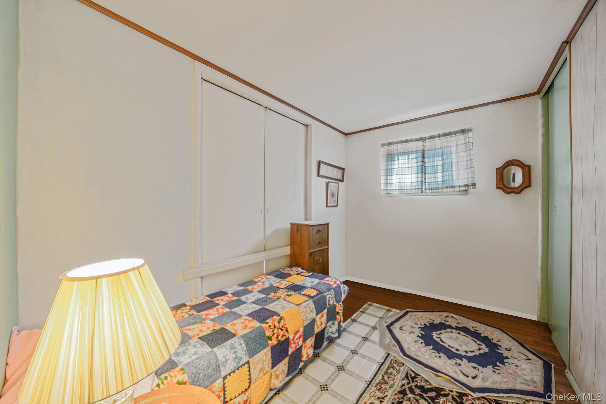 2 Sydney Street Plainview, NY 11803 - Photo 17 of 26 a bedroom with a bed and a window