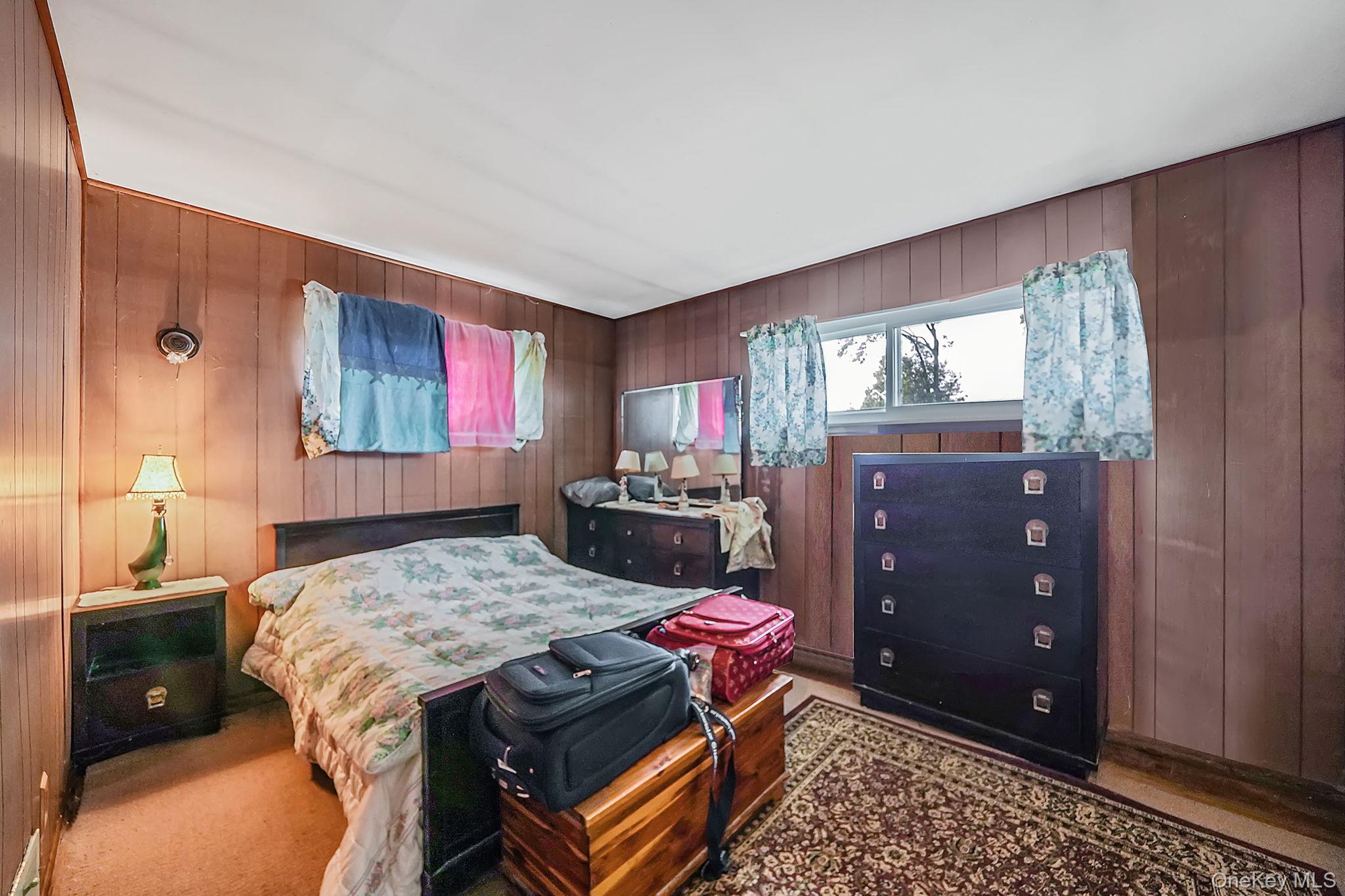 2 Sydney Street Plainview, NY 11803 - Photo 19 of 26 a living room with a couch and a dresser with wooden floor