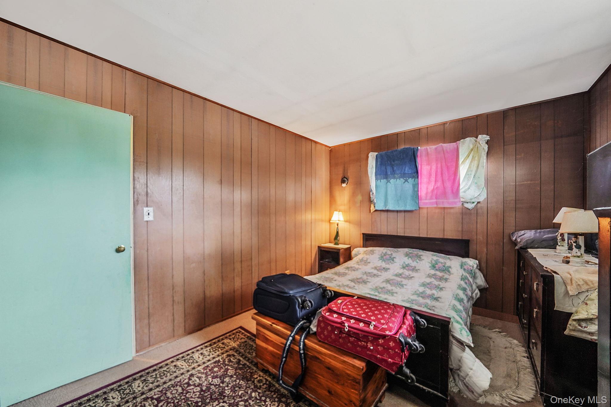 2 Sydney Street Plainview, NY 11803 - Photo 20 of 26 a bedroom with a bed and wooden floor