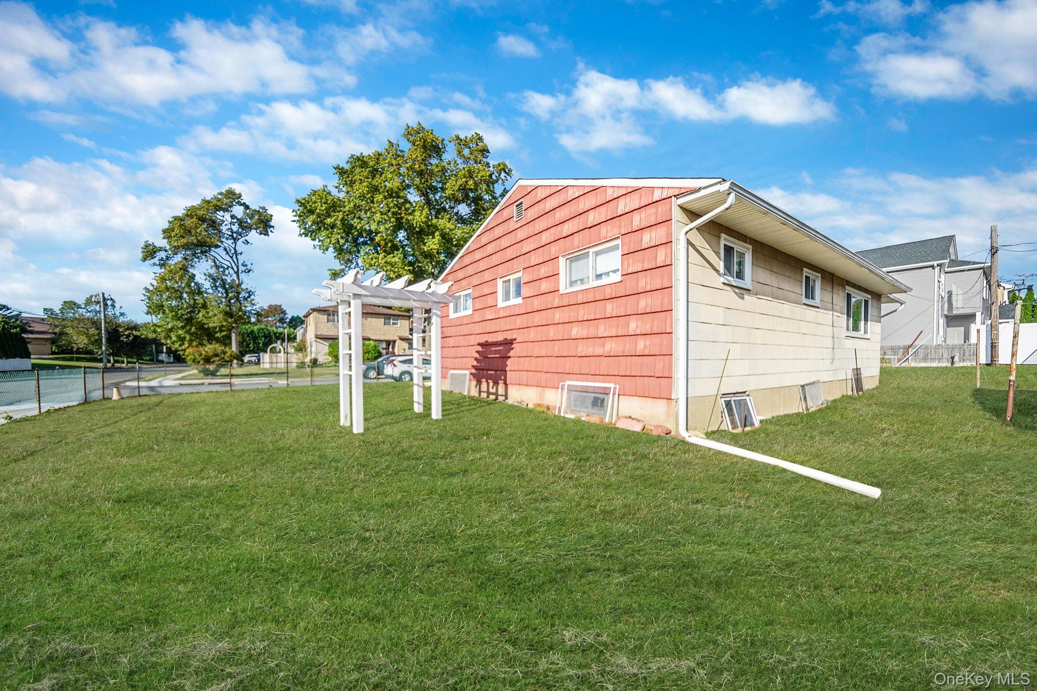 2 Sydney Street Plainview, NY 11803 - Photo 6 of 26 a backyard of a house with lots of green space