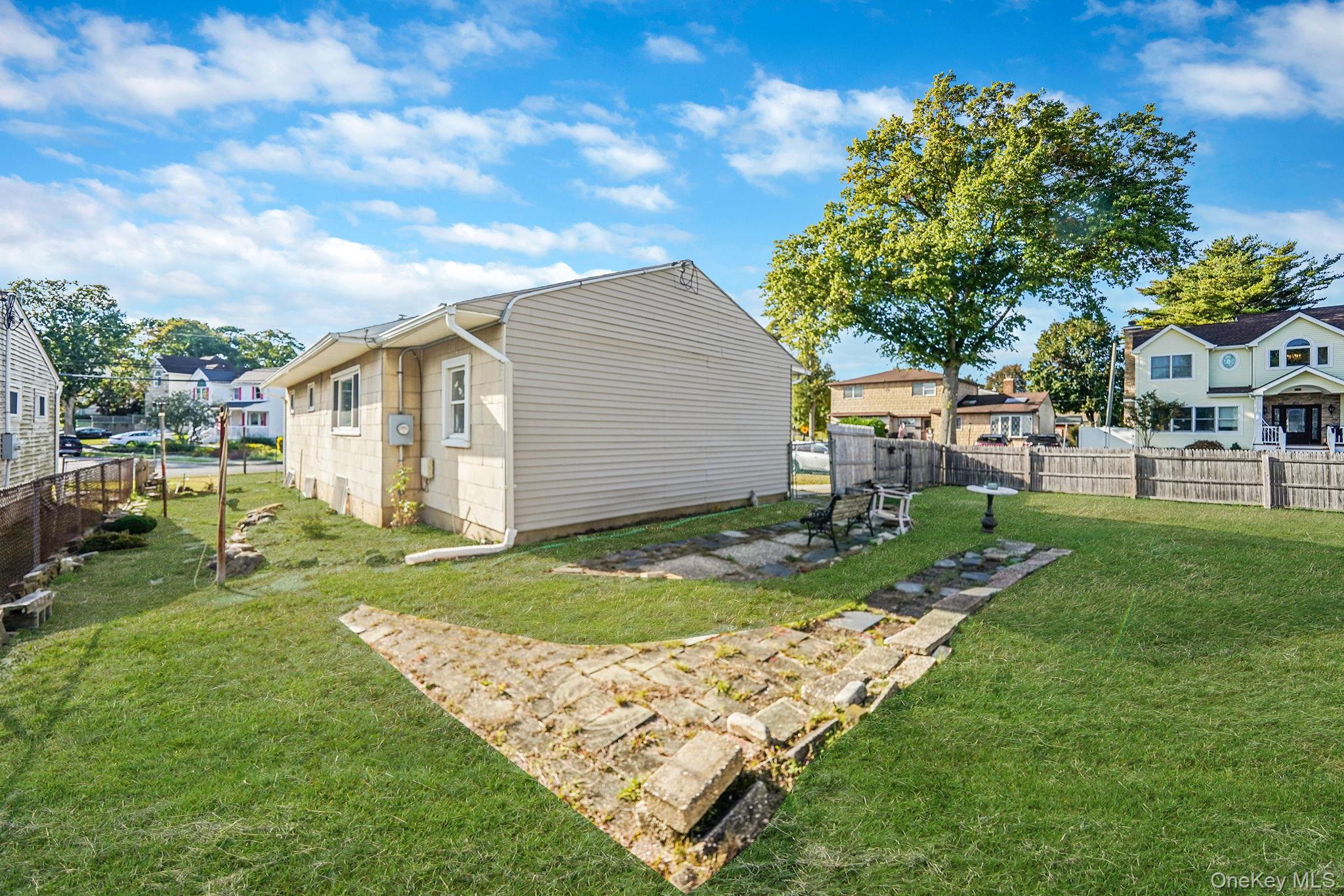 2 Sydney Street Plainview, NY 11803 - Photo 7 of 26 a view of backyard of house with wooden deck and seating
