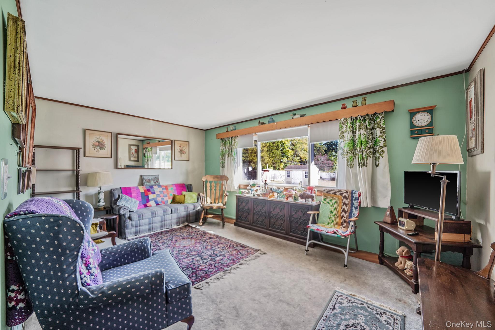 2 Sydney Street Plainview, NY 11803 - Photo 10 of 26 a living room with furniture and a floor to ceiling window