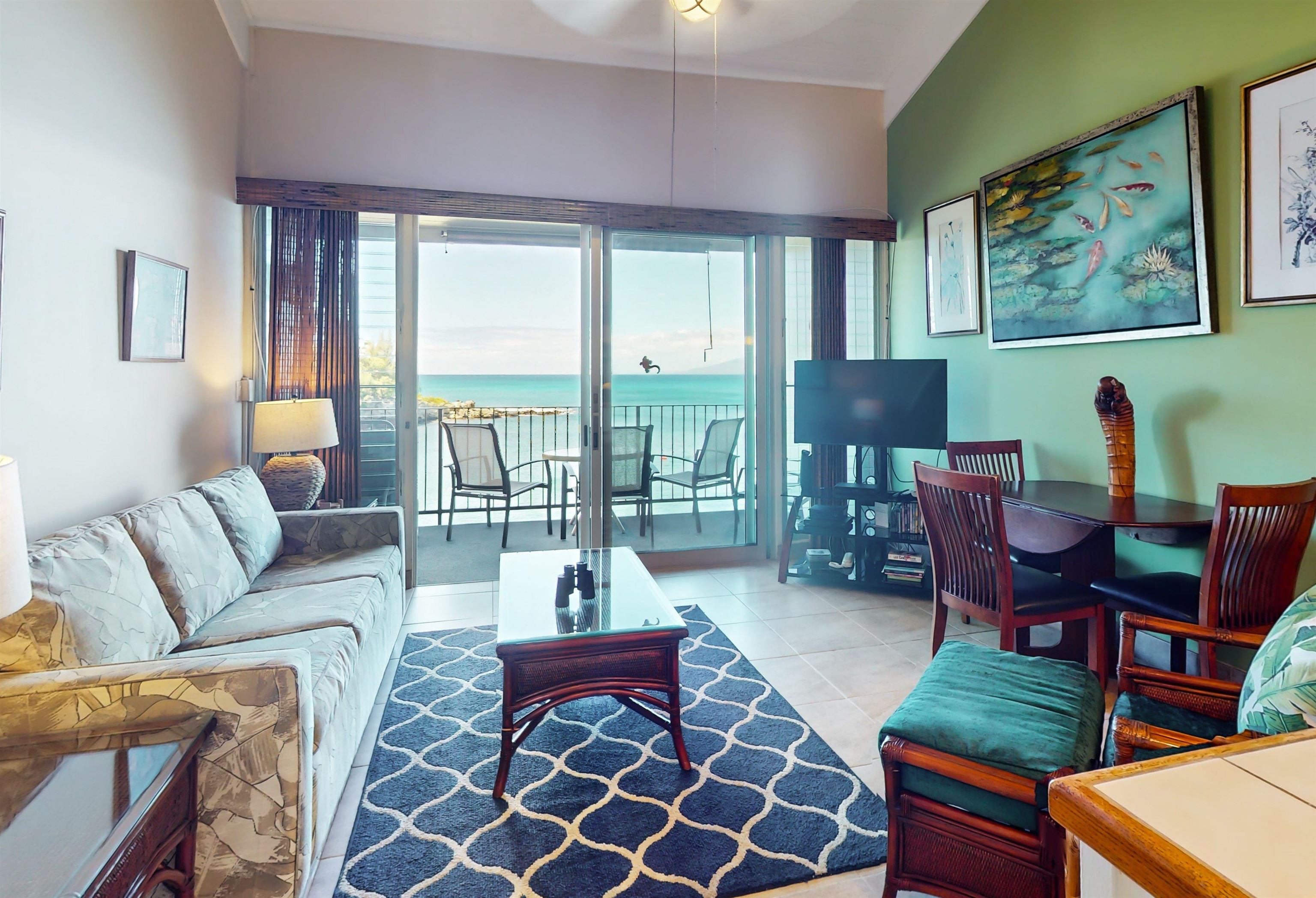 5255 Lower Honoapiilani Road, Unit 219 Lahaina, HI 96761 - Photo 2 of 12 a living room with furniture and a floor to ceiling window